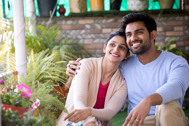 Happy Indian couple sitting on porch